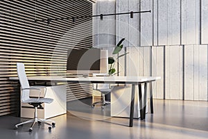 Contemporary office space with a clean aesthetic, wood slats, and potted greenery.