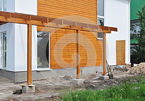 Contemporary Outdoor Terrace. Modern Home Construction with wooden pillars terrace patio installation