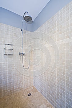 Contemporary shower with natural stone tiles