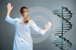 Three dimensional model of dna with scientist working in background