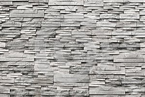 Contemporary wall of light grey, natural stone. Texture