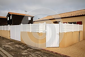 Contemporary white vinyl fence surrounding yard garden protect house with door portal