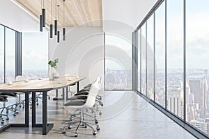 Contemporary wooden and concrete meeting room interior with panoramic city view, daylight and large table with chairs. Corporate
