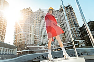 Contemptuous skinny woman wrapping up in her red velvet robe