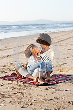 Content African American family on picnic on beach