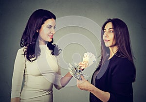 Content business women exchanging money