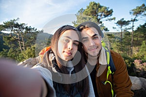 Content couple of hikers taking selfie