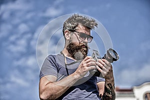 Content creator. Man bearded hipster photographer. Man shooting photos. Old but still good. Manual settings