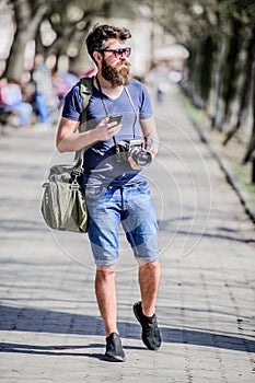 Content creator. Man bearded hipster photographer. Old but still good. Photographer hold vintage camera. Modern blogger