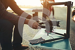 Content creator setting stabilizer gimbal equipment camera for shoot video footage