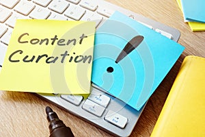 Content Curation. Memo stick on the keyboard.