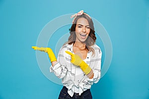 Content happy woman 20s holding copyspace on her palm while wear