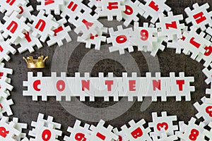 Content is king in advertising or creative communication concept, white puzzle jigsaw building the word content with golden crown