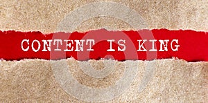 CONTENT IS KING text appearing behind on torn paper