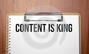 Content is King text on white paper on the wood table