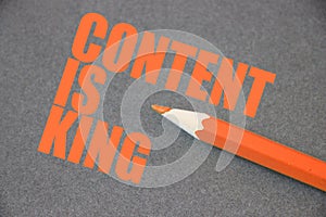 Content is king written on blackboard with orange crayon pencil. Search Engine Optimization concept