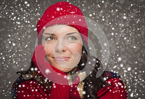 Content Mixed Race Woman Wearing Winter Hat and Gloves Enjoys Snowfall