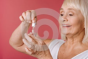 Content retired woman using nail varnish