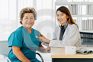 Content senior Asian woman having appointment with doctor at hospital