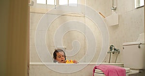 Content and smiling child fully engaged in the joy of bath time