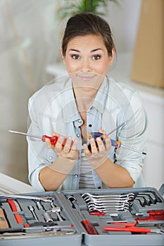 content woman holding tools