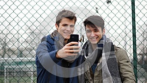 Content young men posing at camera for selfie