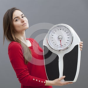 Content young woman holding scales