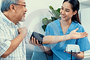 A contented retired man having a blood pressure check by his personal caregiver.