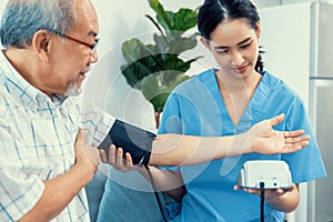 A contented retired man having a blood pressure check by his personal caregiver.