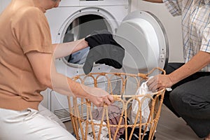 Contented senior couple doing laundry together.