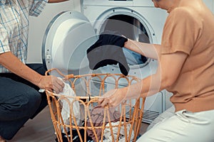 Contented senior couple doing laundry together.