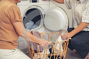 Contented senior couple doing laundry together.