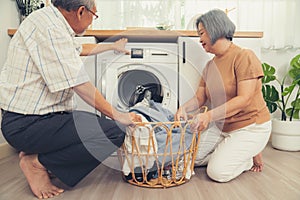 Contented senior couple doing laundry together.