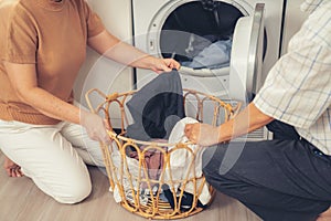 Contented senior couple doing laundry together.