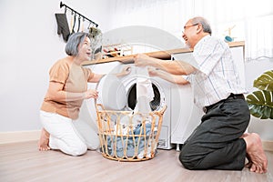 Contented senior couple doing laundry together.