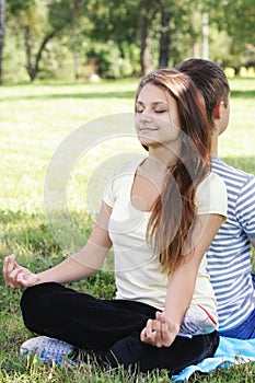 Contented woman relaxing in yoga pose