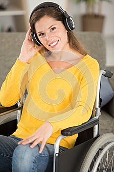 contented woman in wheelchair listening to earphones