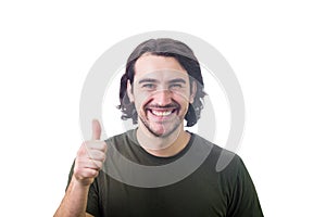 Contented young man, shows thumb up gesture, smiling to camera, isolated on white background. Attractive casual guy, long curly