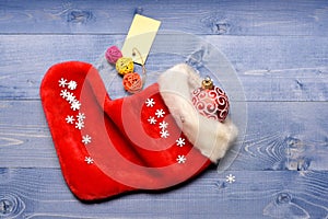 Contents of christmas stocking. Christmas sock toned wood background top view. Fill sock with gifts or presents