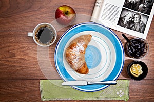 Continental breakfast with coffee, fresh croissants, fruit and good magazine