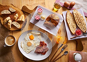 Continental breakfast croissant eggs bacon bread