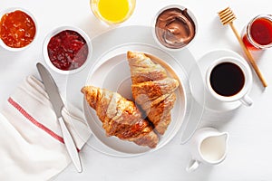 Continental breakfast with croissant, jam, chocolate spread and