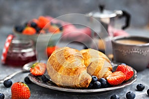 Continental breakfast with croissants, fresh berries, coffee