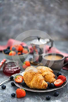 Continental breakfast with croissants, fresh berries, coffee
