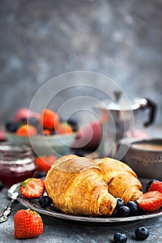 Continental breakfast with croissants, fresh berries, coffee and jam
