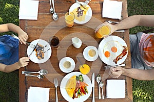Continental breakfast with pancakes, eggs, bacon, orange jiuce and coffee. Top view