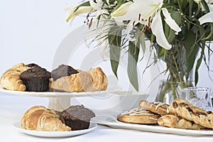 Continental breakfast table setting with pastries and cakes