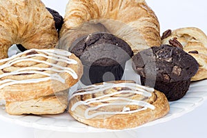 Continental breakfast table setting with pastries and cakes