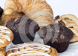 Continental breakfast table setting with pastries and cakes