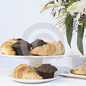 Continental breakfast table setting with pastries and cakes